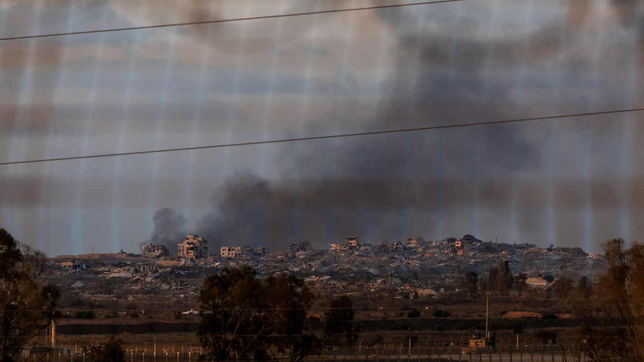 Destruction in Gaza can be seen through the fence of Kibbutz Nahal Oz, near Israel's border with Gaza in southern Israel, October 28, 2025. REUTERS/Ronen Zvulun