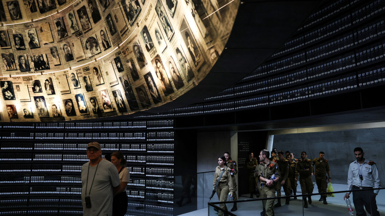 Visitors tour an exhibition, ahead of Israel's national Holocaust memorial day at Yad Vashem, the World Holocaust Remembrance Center, in Jerusalem April 23, 2025. REUTERS/Ronen Zvulun