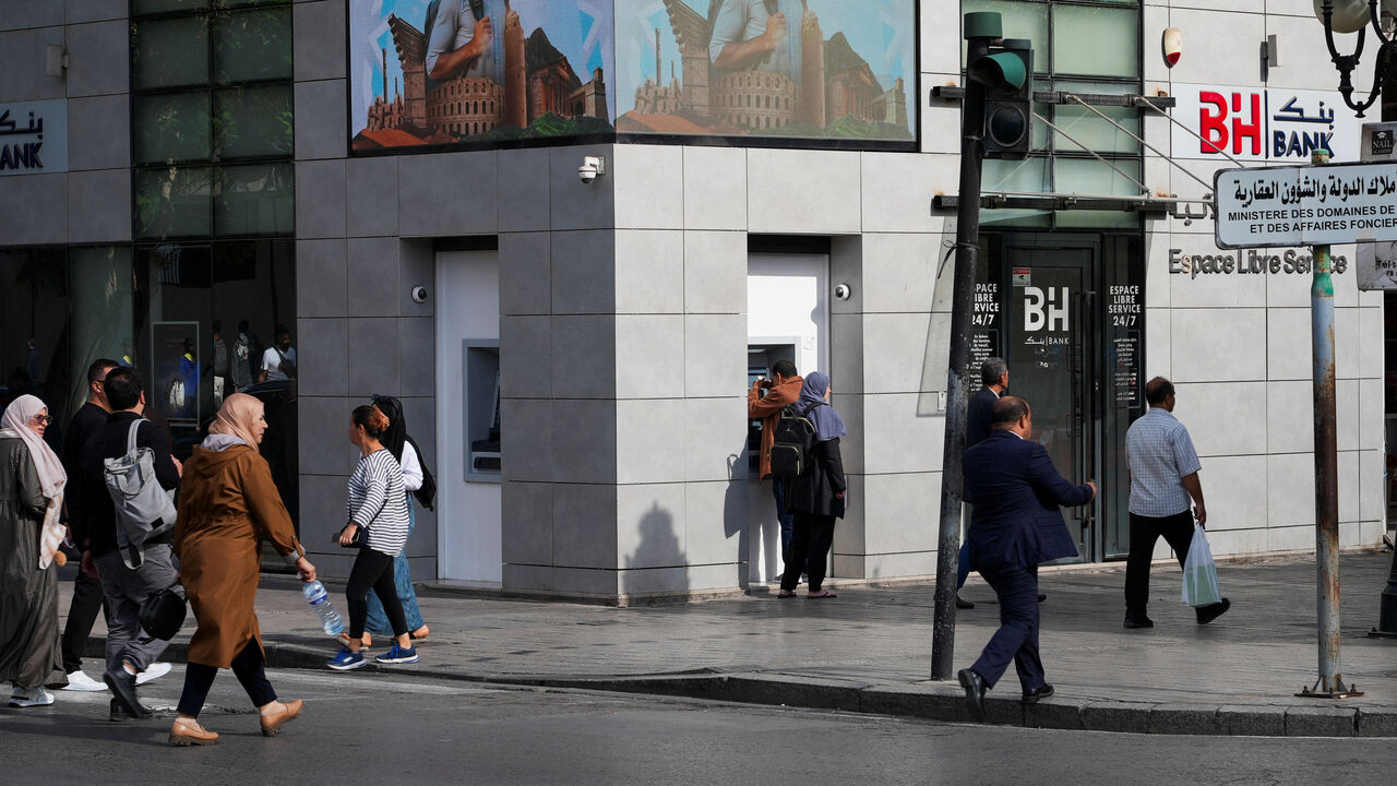 A man withdraws money from an ATM at a bank branch as bank workers begin a two-day strike to demand pay rises, in Tunis, Tunisia, November 3, 2025. REUTERS/ Jihed Abidellaoui