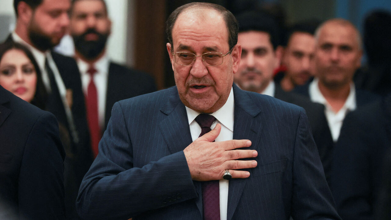 FILE PHOTO: Former Iraqi Prime Minister Nouri al-Maliki gestures as he arrives to vote during Iraq's provincial council elections, at a polling station in Baghdad, Iraq, December 18, 2023. REUTERS/Ahmed Saad/File Photo