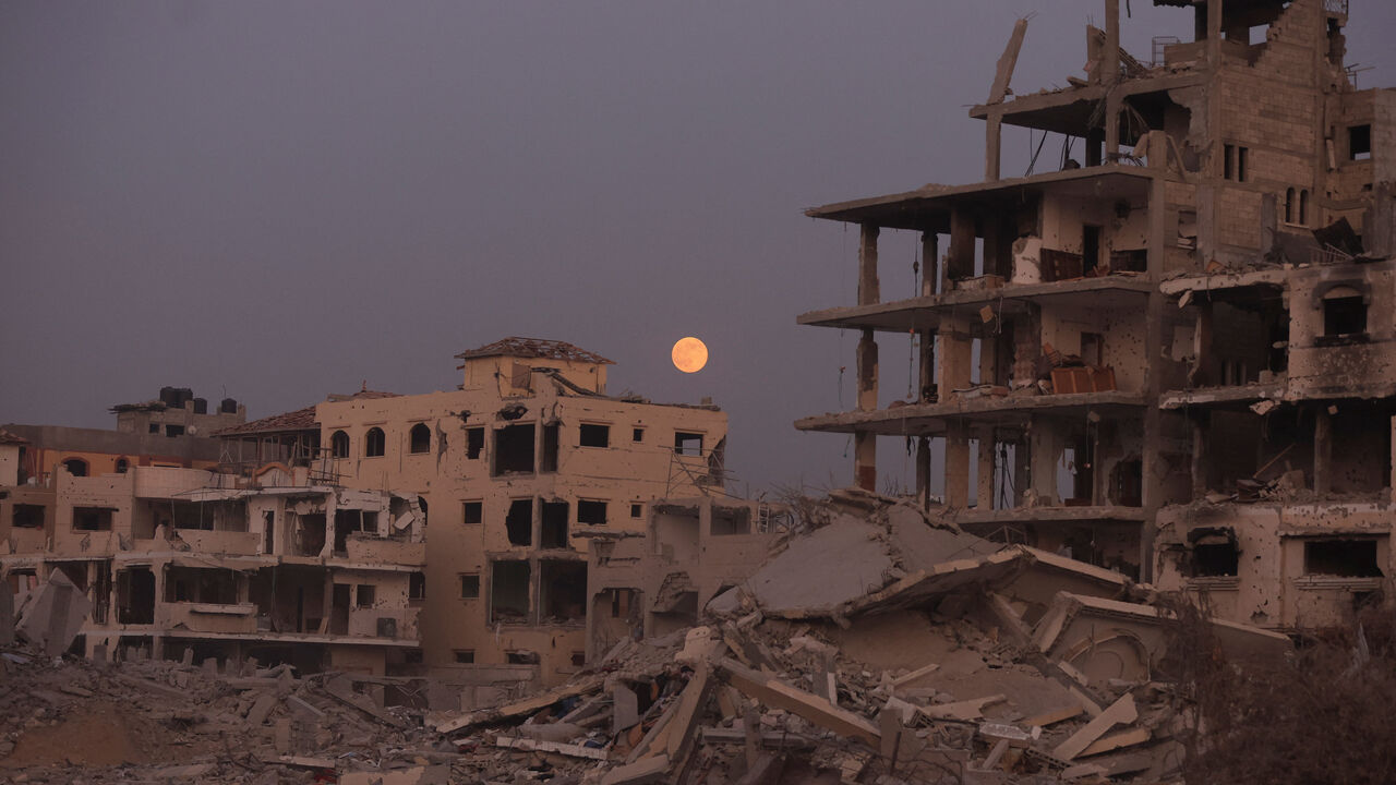 The Beaver Moon supermoon rises above destroyed buildings amid a ceasefire between Israel and Hamas, in Gaza City, November 5, 2025. REUTERS/Dawoud Abu Alkas