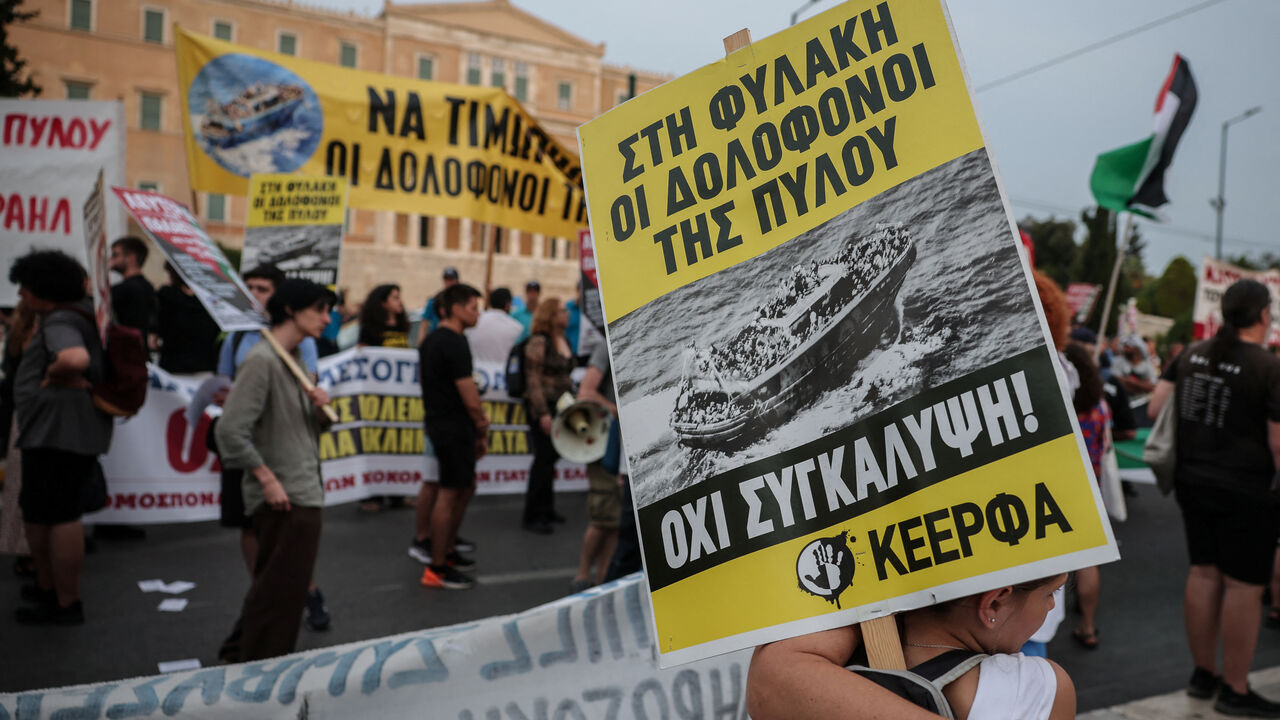 A protester carries a placard reading "no to cover-up" as activists, survivors and other protesters gather to mark the second anniversary of one of the Mediterranean's worst shipwrecks in 2023 off Greece's southwestern town of Pylos, in Athens, Greece, June 21, 2025. REUTERS/Louisa Gouliamaki