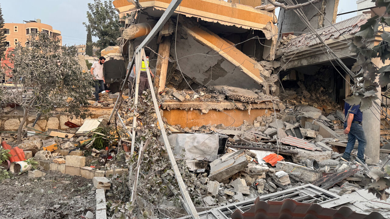 People inspect a damaged site after Israeli strikes following Israeli military's evacuation orders, in Tayr Debba, southern Lebanon November 6, 2025. REUTERS/Ali Hankir