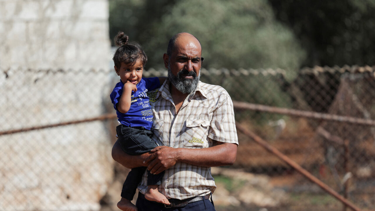 Faisal Sbeih, 46, who fled sectarian fighting in Syria's Sweida province, stands outside his tent in the Daraa countryside, Syria, September 15, 2025. REUTERS/Khalil Ashawi