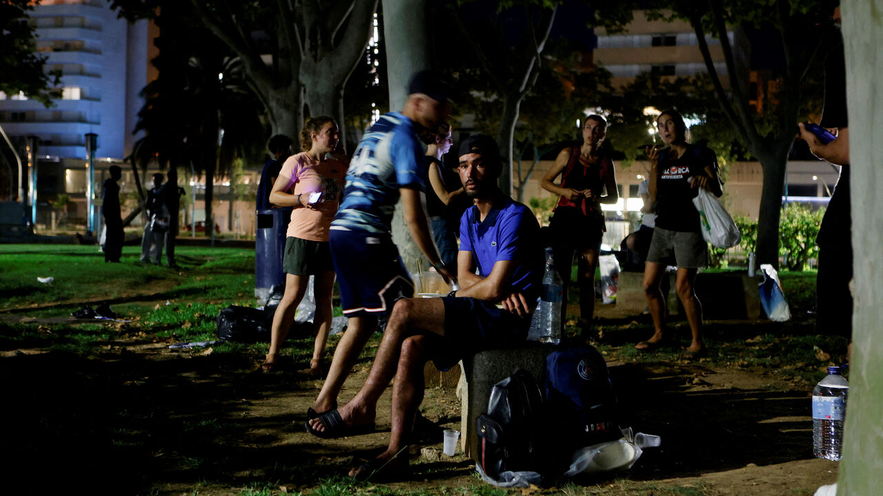 An Algerian migrant sits in a public park after arriving from Algeria earlier in the day, as more than 30 boats carrying about 600 irregular migrants have reached the Balearic Islands since Monday, according to officials, in Palma de Mallorca, Spain, August 12, 2025. REUTERS/Francisco Ubilla