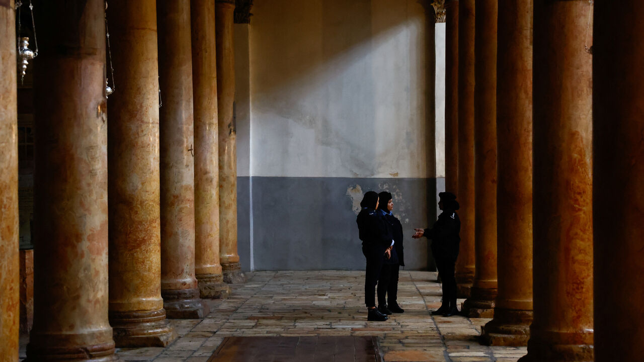 Palestinian police officers stand in the Church of the Nativity on Christmas Eve, in Bethlehem, in the Israeli-occupied West Bank, December 24, 2023. REUTERS/Clodagh Kilcoyne