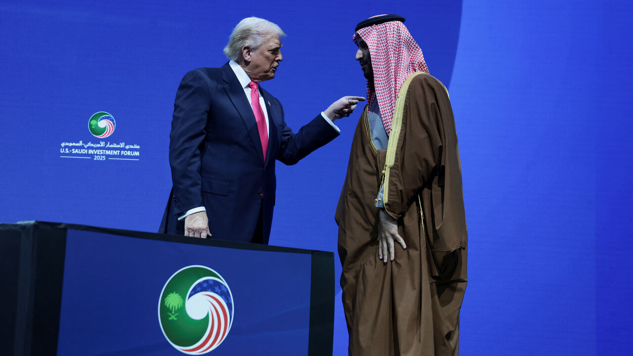 U.S. President Donald Trump and Crown Prince and Prime Minister Mohammed bin Salman of Saudi Arabia interact during the U.S.-Saudi Investment Forum in Washington, D.C., U.S., November 19, 2025. REUTERS/Evelyn Hockstein