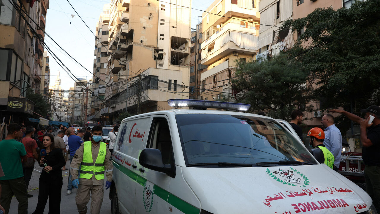 An ambulance vehicle stands near the site of an Israeli strike on a building, after Israeli military said on Sunday that it struck a militant from the Lebanese Iran-aligned Hezbollah group, in Beirut's southern suburbs, Lebanon November 23, 2025. REUTERS/Mohamed Azakir