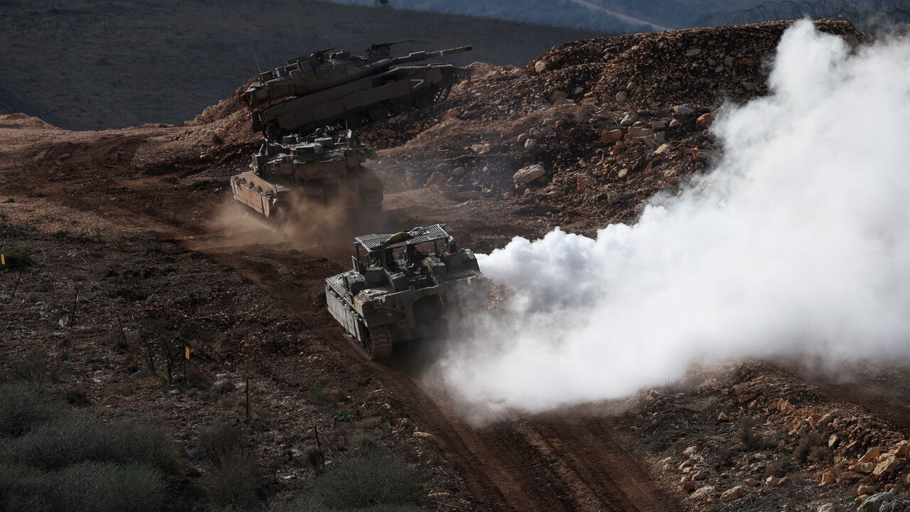 Israeli military vehicles manoeuvre along the Israel-Lebanon border, as seen from northern Israel, November 24, 2025. REUTERS/Shir Torem