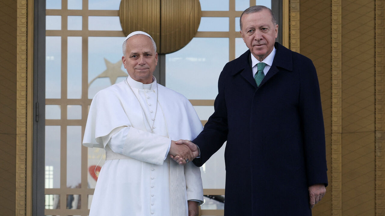 Pope Leo XIV and Turkish President Tayyip Erdogan shake hands as they meet at the Presidential Palace, during the pope's first apostolic journey, in Ankara, Turkey, November 27, 2025. REUTERS/Umit Bektas