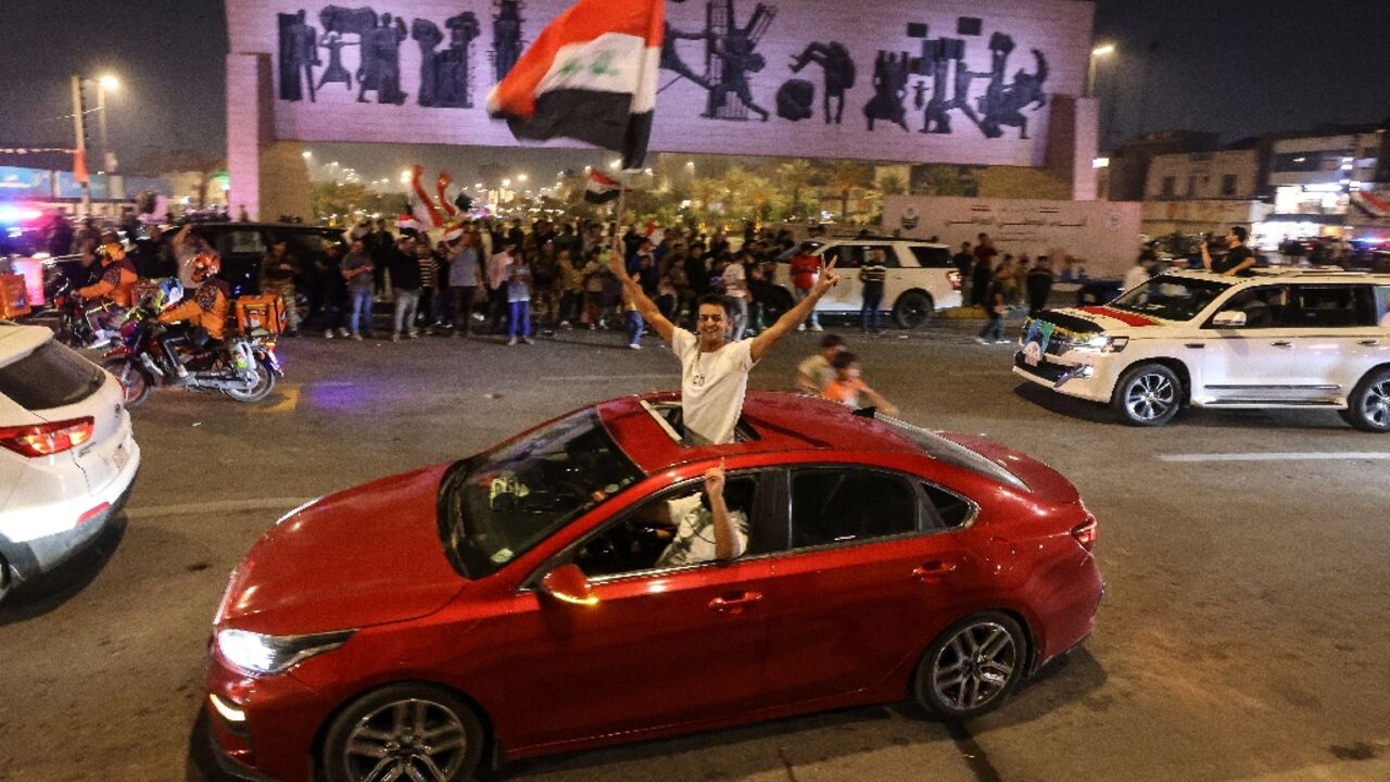 Supporters of incumbent Iraqi Prime Minister Mohammed Shia al-Sudani celebrate following the announcement of preliminary election results in Baghdad
