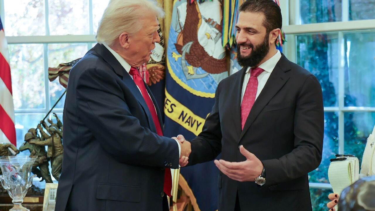 US President Donald Trump shakes hands with Syrian President Ahmed al-Sharaa at the White House in Washington 