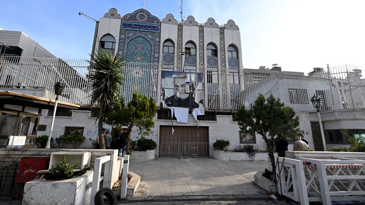 A picture taken in Damascus on Dec. 9, 2024, shows the building of the Iranian Embassy, which was ransacked after anti-government fighters took the Syrian capital the previous day, with a portrait of Iran's slain Revolutionary Guards commander, Qasem Soleimani, still hanging on its fence.
