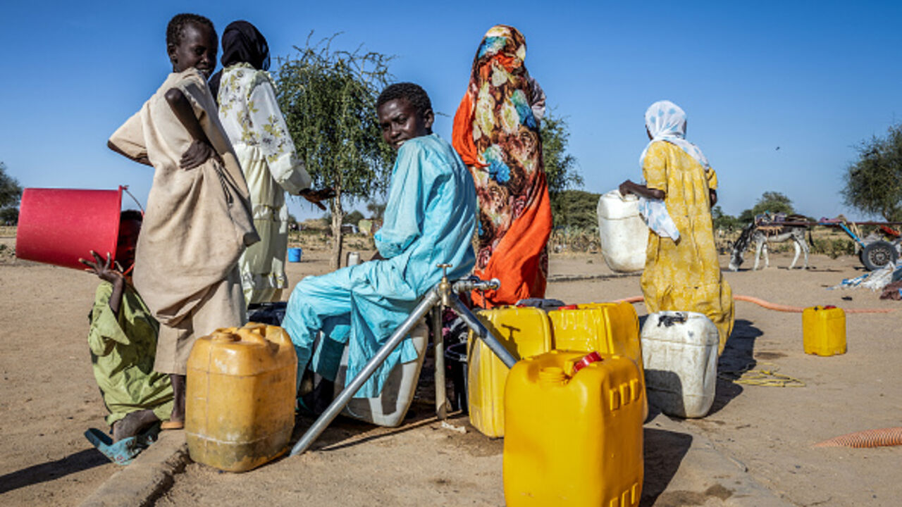 Sudanese refugees fill water containers at a water point in the Tine transit camp in Chad on November 10, 2025. (JORIS BOLOMEY/AFP via Getty Images)