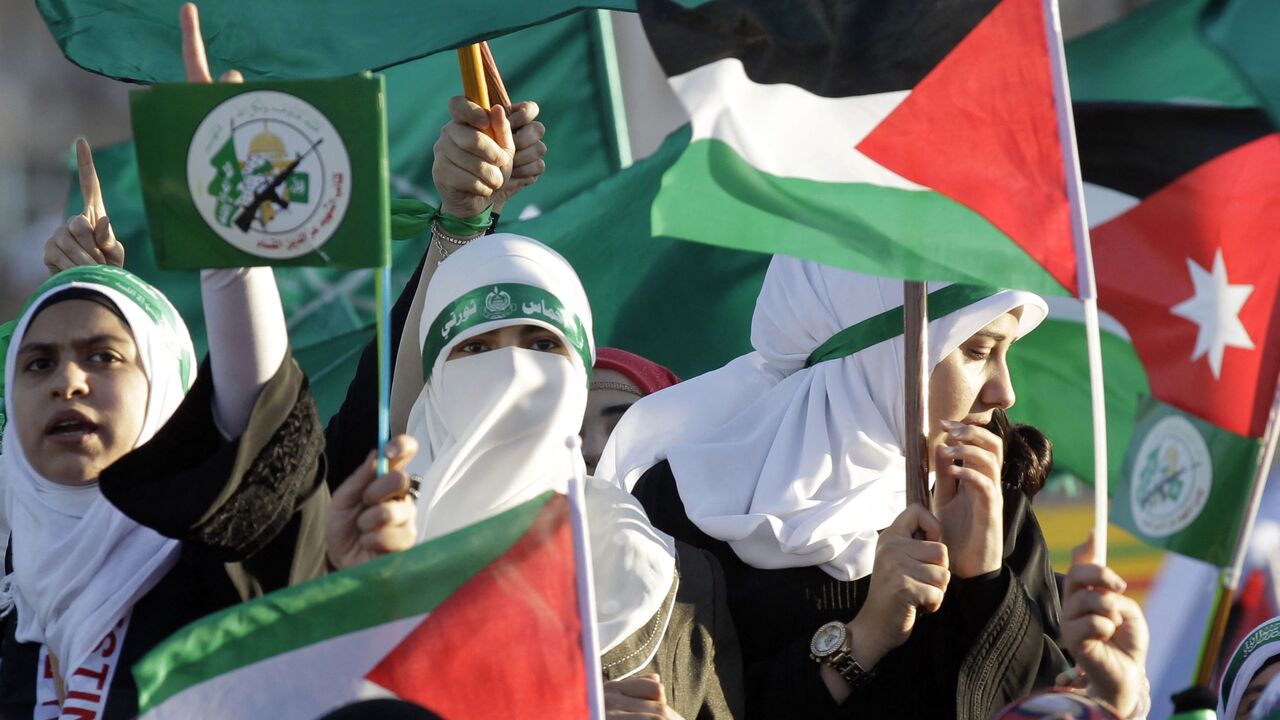 Jordanian supporters of the Muslim Brotherhood wave the Palestinian flag as they gather during a protest to celebrate the "Gaza victory" in the war against Israel, in the capital Amman, on Aug. 8, 2014. 