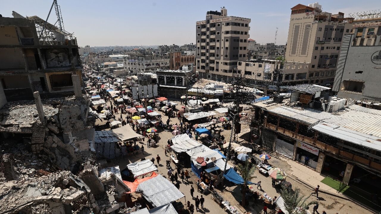 Palestinians gather at a market at the Nuseirat refugee camp in the central Gaza Strip