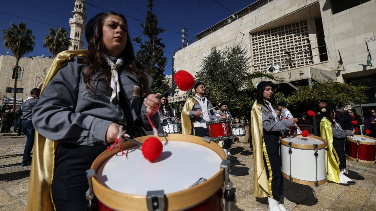 Christian scouts march during Christmas eve celebrations at the Manger Square outside the Church of the Nativity in Bethlehem, in the Israeli-occupied West Bank