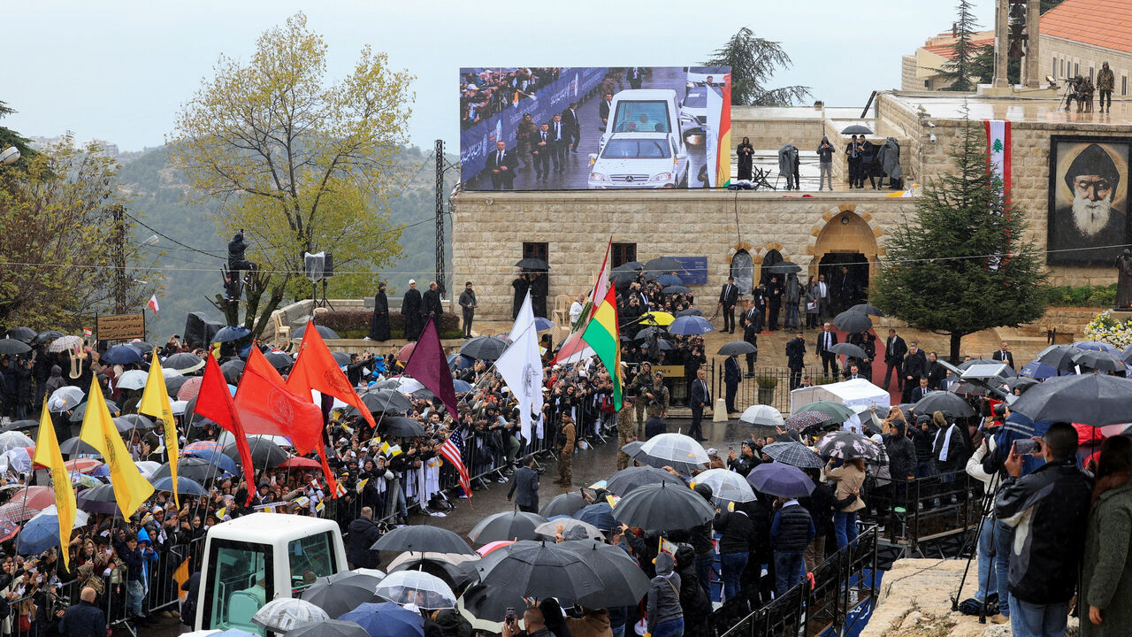 People watch Pope Leo XIV arriving to visit the tomb of Saint Charbel Makhlouf at the Monastery of Saint Maron, during his first apostolic journey, in Annaya, Lebanon December 1, 2025. REUTERS/Mohamed Azakir