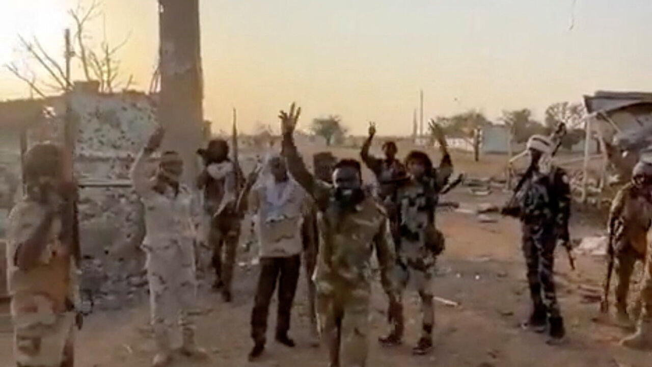 Members of Sudan's paramilitary Rapid Support Forces (RSF) stand in front of the main gate of the 22nd SAF Infantry Division, in Babanusa, Sudan, in this screengrab obtained from a social media video released December 1, 2025. Social Media/via REUTERS