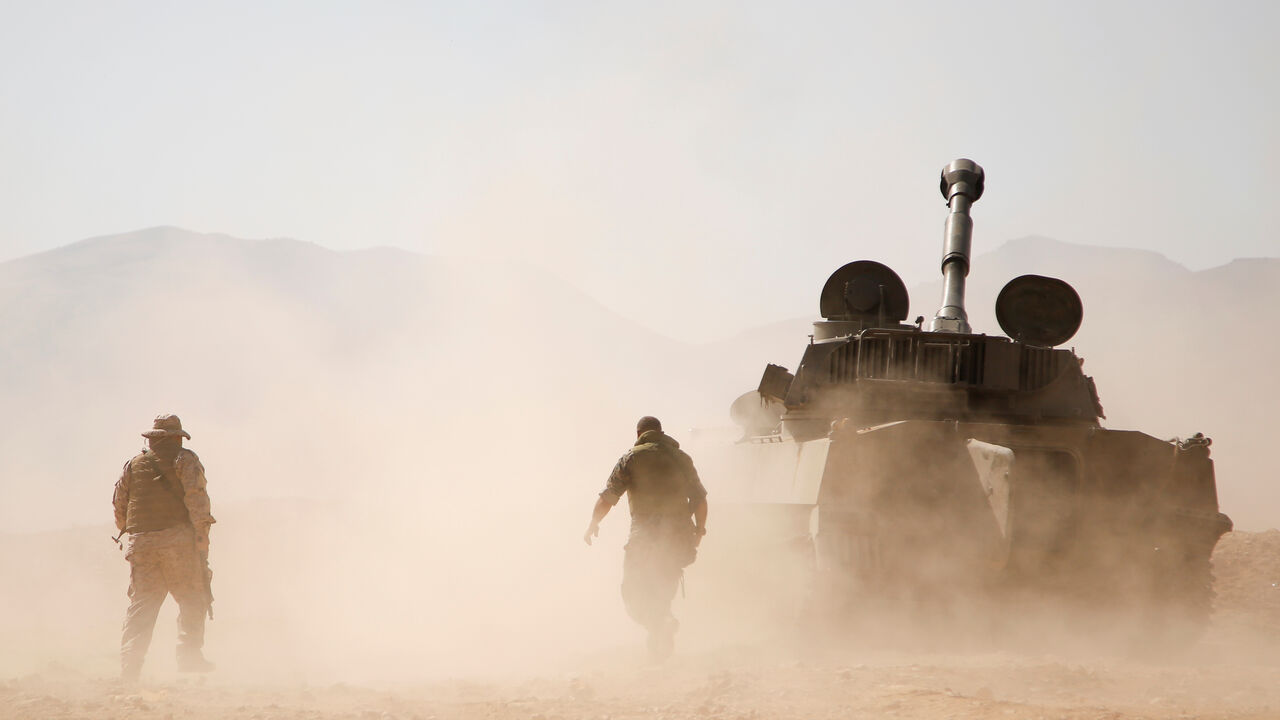 Hezbollah fighter walk near a military tank in Western Qalamoun, Syria August 23, 2017. REUTERS/Omar Sanadiki