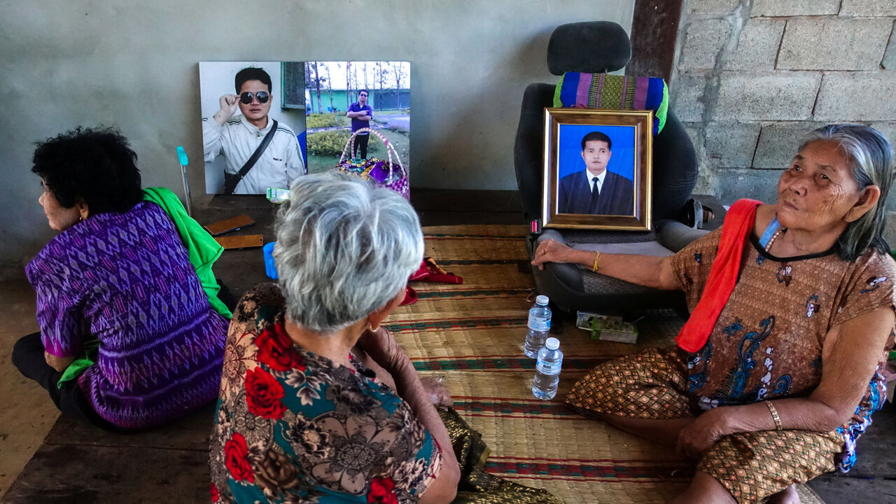 On Rinthalak, 80, mother and relatives of deceased Thai hostage Sudthisak Rinthalak, who was kidnapped to Gaza in the deadly October 7, 2023, attack by Hamas, sit next to his pictures at their house in Nong Khai province, Thailand, December 5, 2025. REUTERS/Thomas Suen