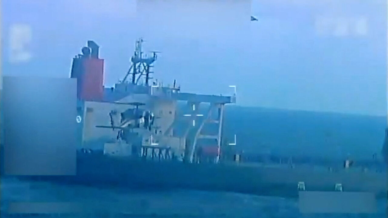 A U.S. military helicopter flies near an oil tanker during a raid described by U.S. Attorney General Pam Bondi as its seizure by the United States off the coast of Venezuela, December 10, 2025, in a still image from video.  U.S. Attorney General/Handout via REUTERS