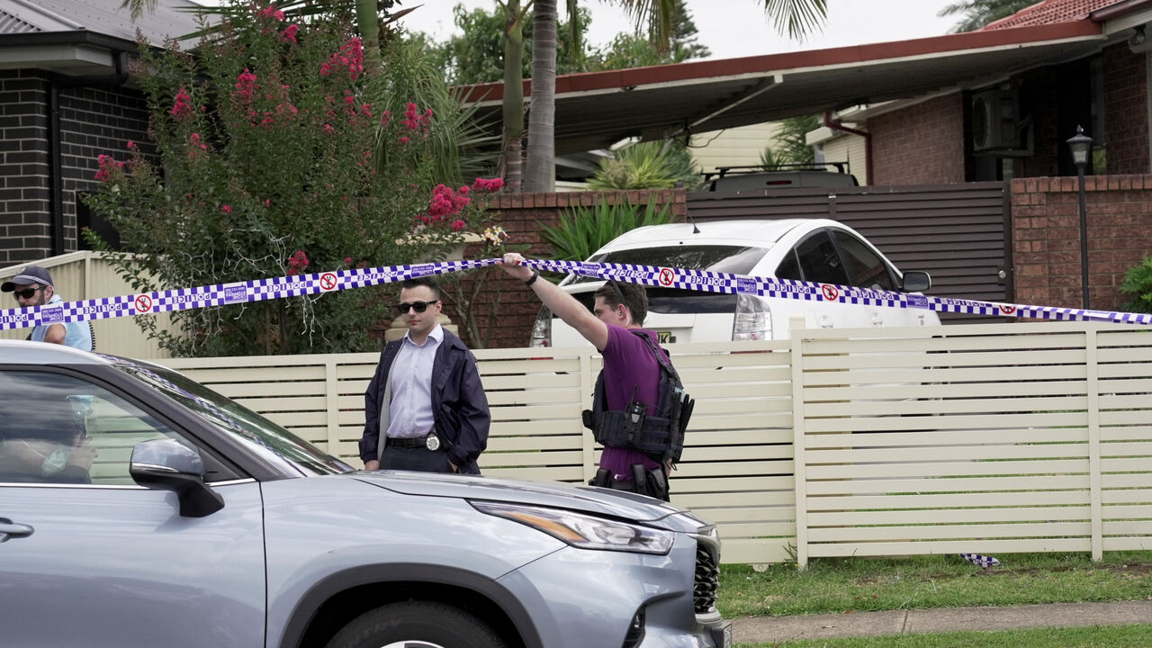 Police officers stand guard outside the house of the suspects of a shooting incident on a Jewish holiday celebration at Bondi Beach, in Bonnyrigg, Sydney, Australia, December 15, 2025. REUTERS/Alasdair Pal