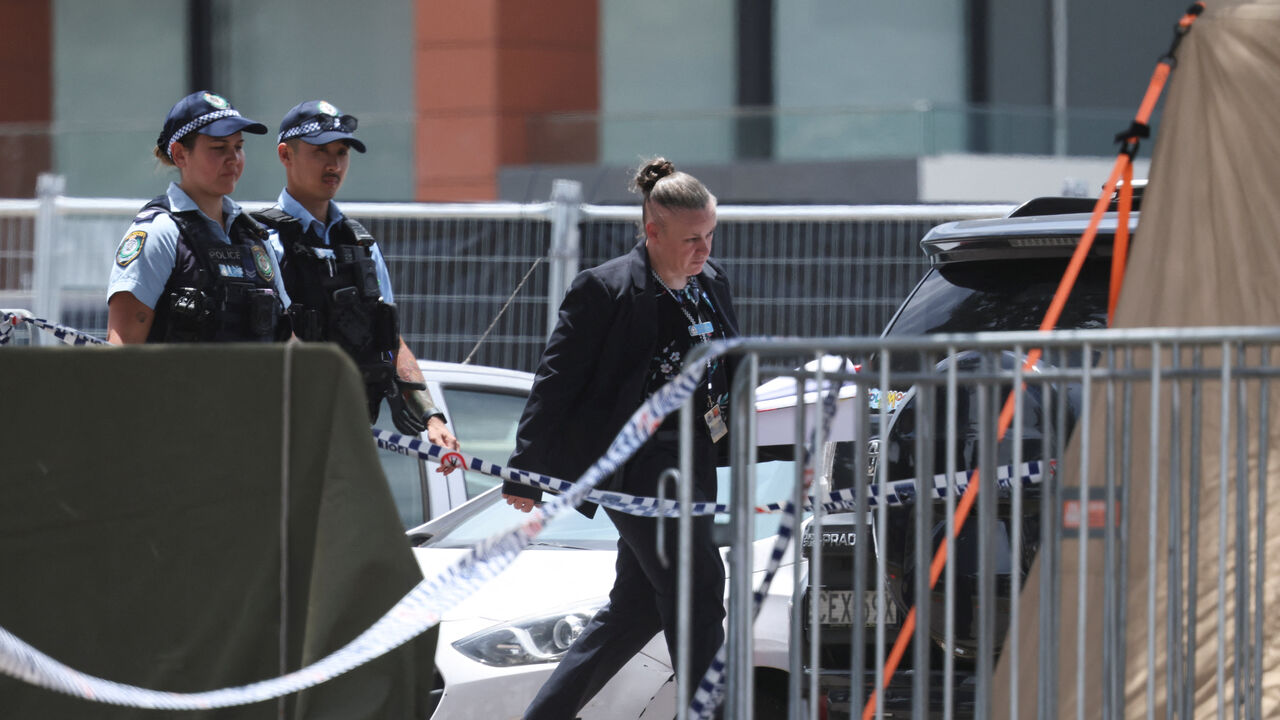 Police officers enter a tent at the scene of a shooting during a Jewish holiday celebration at Bondi Beach, in Sydney, Australia, December 15, 2025. REUTERS/Hollie Adams/File Photo