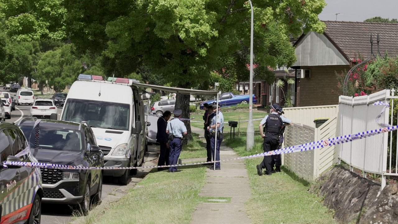 Police officers stand guard outside the house of the suspects of a shooting incident on a Jewish holiday celebration at Bondi Beach, in Bonnyrigg, Sydney, Australia, December 15, 2025. REUTERS/Alasdair Pal/File Photo