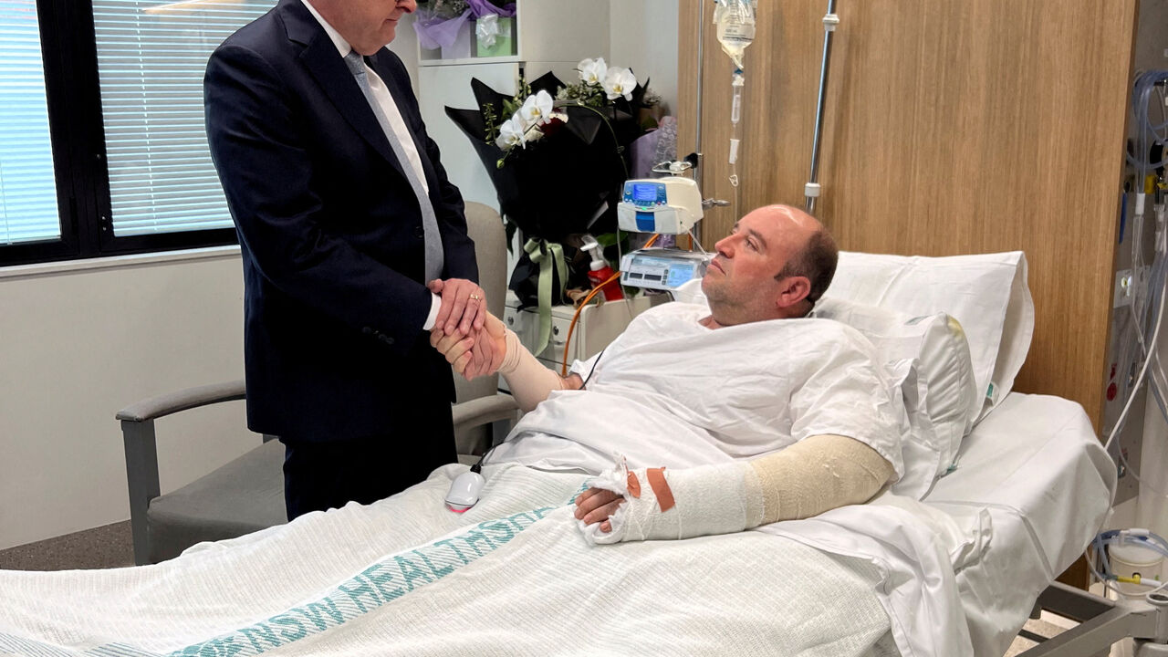 Australia's Prime Minister Anthony Albanese visits Ahmed al Ahmed, the bystander who charged at one of the gunmen and seized his rifle during the deadly shooting at Bondi Beach, at St George Hospital in Sydney, Australia. Prime Minister's Office/Handout via REUTERS
