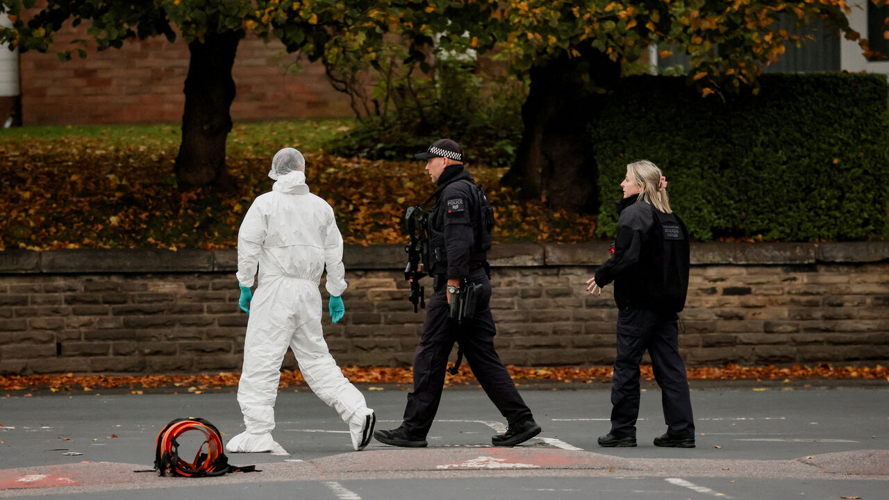 FILE PHOTO: A forensic technician and police officers work at the scene after a man drove a car into pedestrians and stabbed a security guard in an attack at a synagogue where worshippers were marking Yom Kippur, the holiest day on the Jewish calendar, according to the British police, in north Manchester, Britain, October 2, 2025. REUTERS/Phil Noble/File Photo