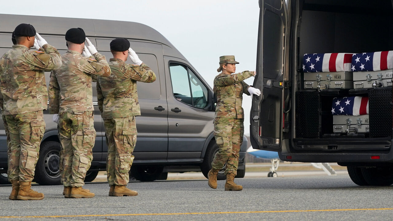 Members of the military salute during a dignified transfer of the remains of two Iowa National Guard members killed in Syria, Sgt. Edgar Torres Tovar and Sgt. William Howard, and Ayad Mansoor Sakat, of Macomb, Michigan, who was working as an interpreter in Syria, at Dover Air Force Base in Dover, Delaware, U.S., December, 17, 2025. REUTERS/Nathan Howard