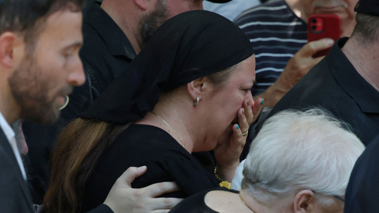 The mother of Matilda, 10, who was killed during the mass shooting at Bondi beach on Sunday, leaves her funeral in Sydney, Australia, December 18, 2025. REUTERS/Hollie Adams