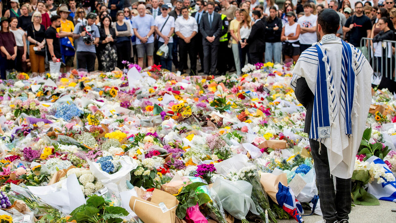 A member of the Jewish community stands at a floral memorial in honour of the victims of the mass shooting targeting a Hanukkah celebration on Sunday, at Bondi Beach, in Sydney, Australia, December 16, 2025. REUTERS/Jeremy Piper