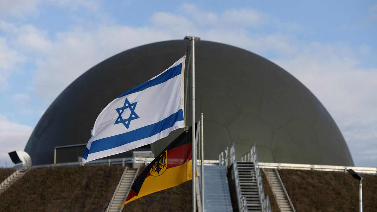 Flags flutter in front of a radom of the "Arrow Weapon System for Germany" pictured in Annaburg, Germany, December 3, 2025. REUTERS/Axel Schmidt