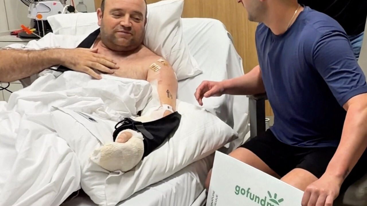 Influencer Zachery Dereniowski gives a check of 2,533,585 dollars to Ahmed al Ahmed, the bystander who is hailed as the "Bondi hero" after he charged at one of the gunmen and seized his rifle during the deadly shooting at Bondi Beach, in Sydney, Australia in this screengrab taken from social media video released December 19, 2025.  @mdmotivator via TikTok/via REUTERS