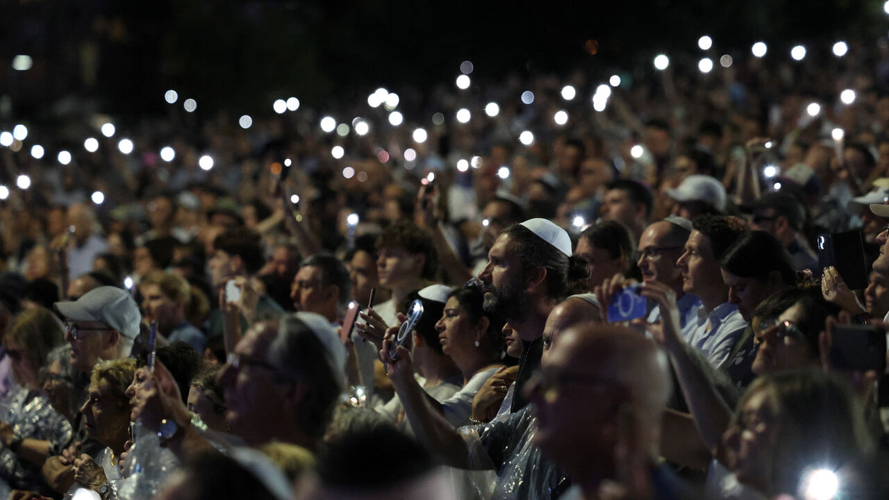 People attend the ‘Light Over Darkness’ vigil honouring victims and survivors of a deadly mass shooting during a Jewish Hanukkah celebration at Bondi Beach on December 14, in Sydney, Australia, December 21, 2025. REUTERS/Hollie Adams