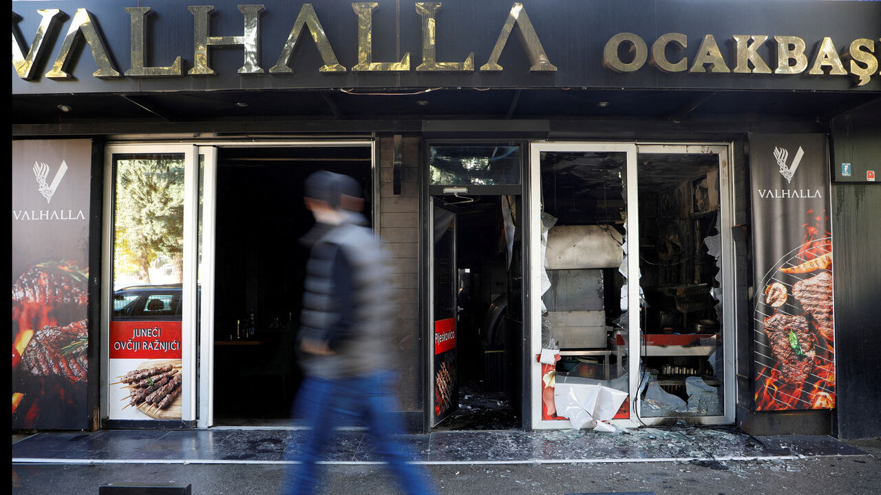 FILE PHOTO: A man looks as he walks past a demolished Turkish owned restaurant in downtown, after a man was stabbed and wounded in a late-night incident in Podgorica, Montenegro, October 27, 2025. REUTERS/Stevo Vasiljevic/File Photo