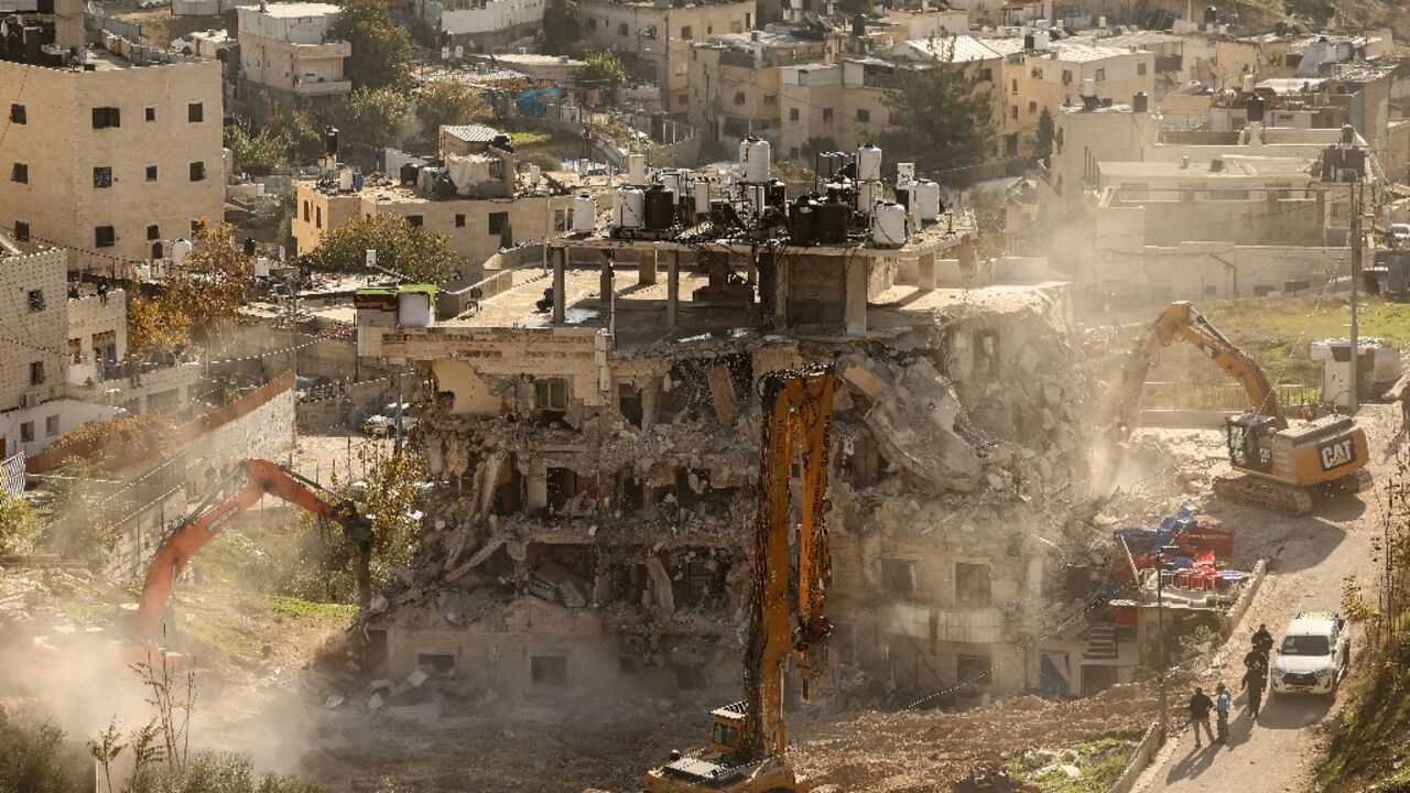 A residential building is demolished in east Jerusalem, where Israeli officials say they are targeting what they describe as unauthorised construction