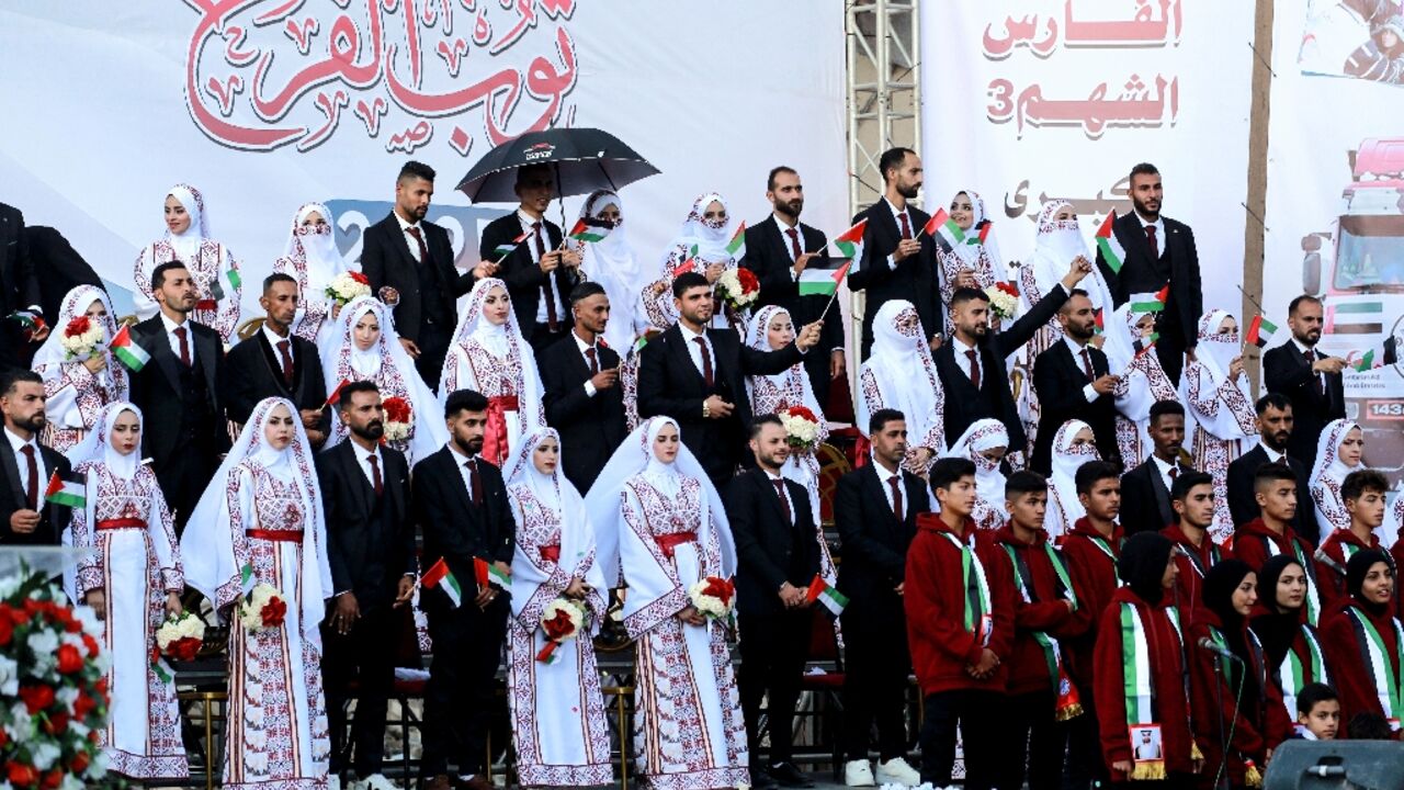Some 54 couples tied the knot in a mass wedding ceremony in Khan Yunis in southern Gaza -- a defiant celebration of life 