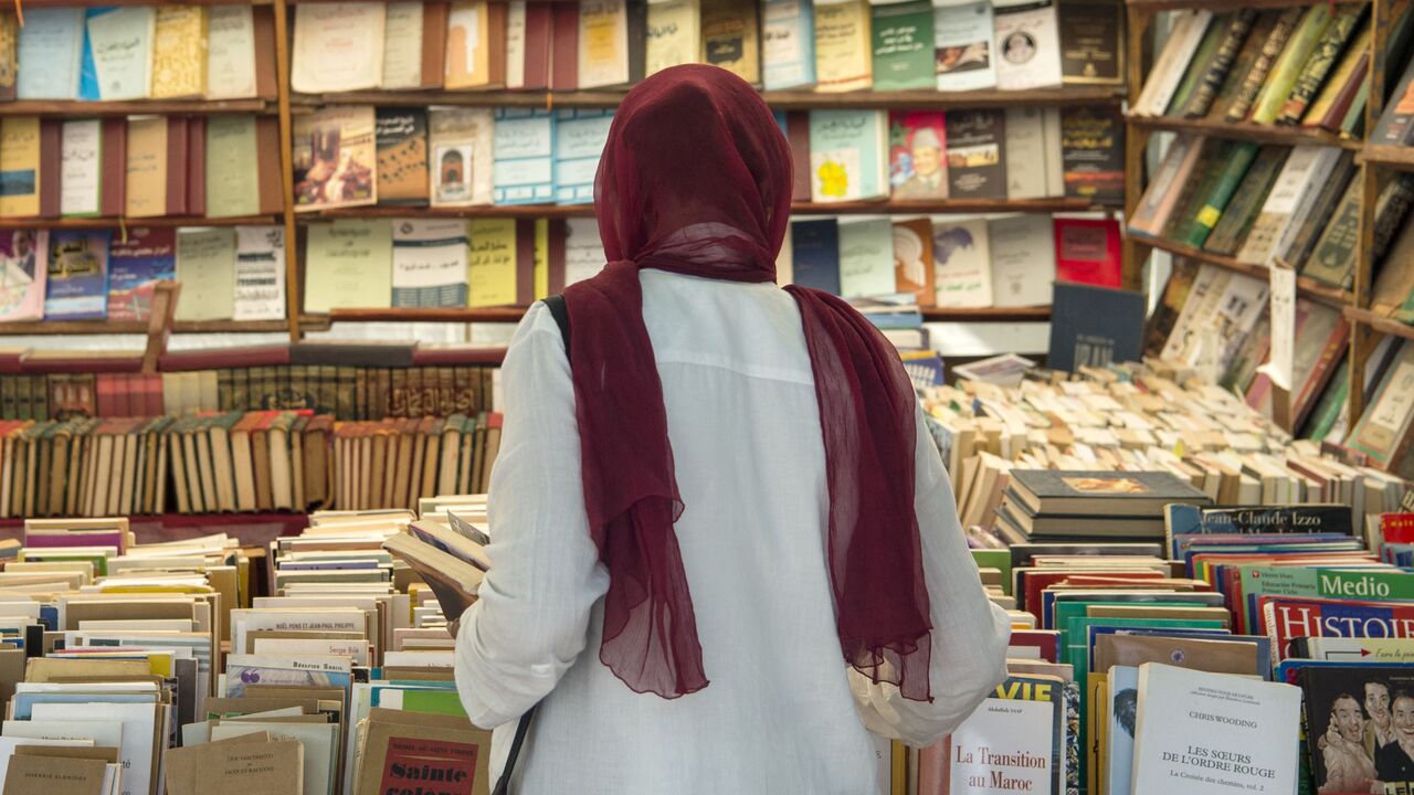 A customer browses books at a bookshop in the Moroccan capital Rabat on August 9, 2018. On the main arteries of old Rabat, dozens of itinerant booksellers offer books in French, Arabic, and sometimes in English, up to ten times cheaper than their originals. Despite being prohibited, the pirated-books market is largely tolerated in cities across the North African kingdom. (Photo by FADEL SENNA / AFP) (Photo by FADEL SENNA/AFP via Getty Images)