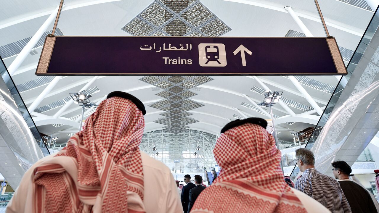People walk on the platform of the Haramain High Speed Rail Network at the airport station in the Red Sea city of Jeddah, on Dec. 12, 2019.