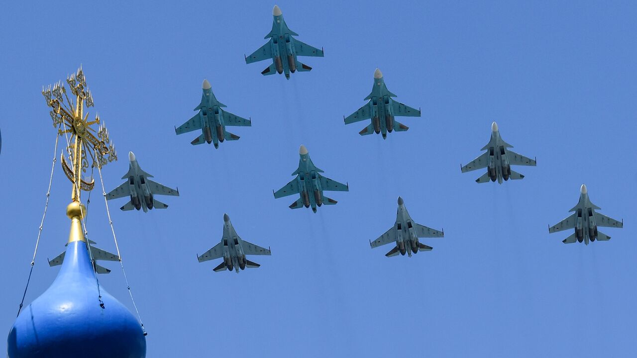 Russian Sukhoi Su-35S fighter aircrafts, Su-34 military fighter jets and Su-30SM jet fighters fly over downtown Moscow during a military parade on June 24, 2020. 