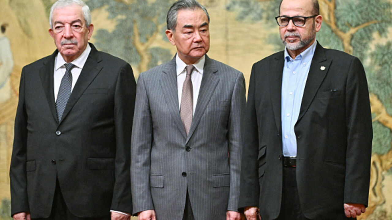 Mahmoud al-Aloul, Vice Chairman of the Central Committee of Palestinian organization and political party Fatah, China's Foreign Minister Wang Yi, and Mussa Abu Marzuk, senior member of  Hamas, attend an event at the Diaoyutai State Guesthouse in Beijing on July 23, 2024. (PEDRO PARDO/AFP via Getty Images)