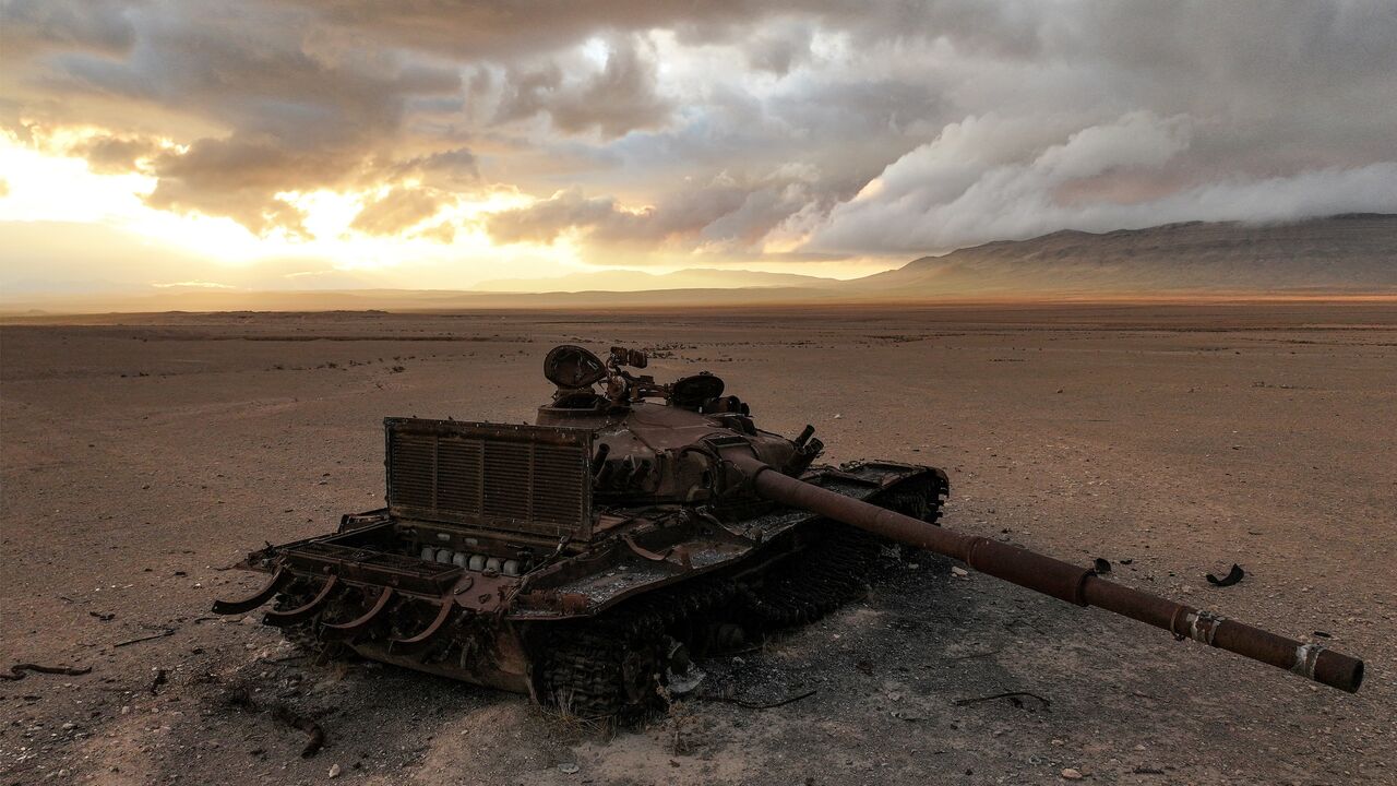 A destroyed Syrian army battle tank lies abandoned near the ancient ruins of Palmyra in central Syria on Feb. 7, 2025. 