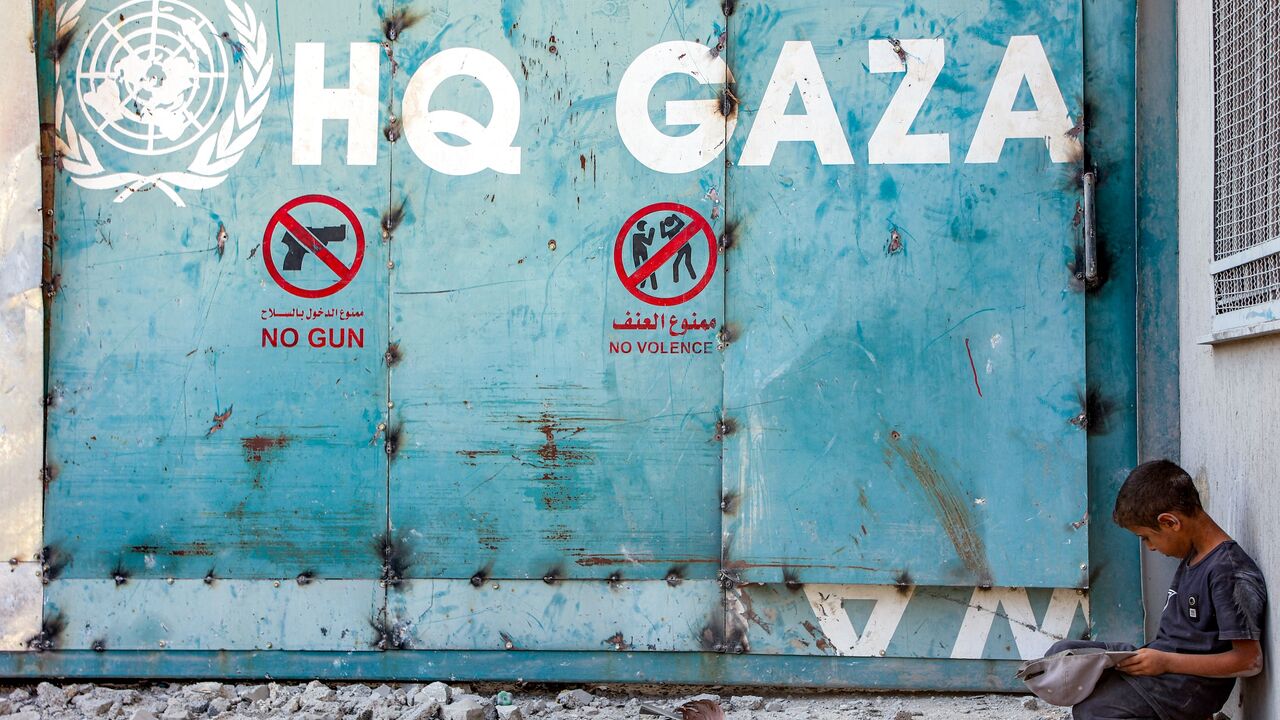 A boy sits outside the entrance to the United Nations Relief and Works Agency for Palestine Refugees (UNRWA) building complex in Gaza City, on Sept. 6, 2025.