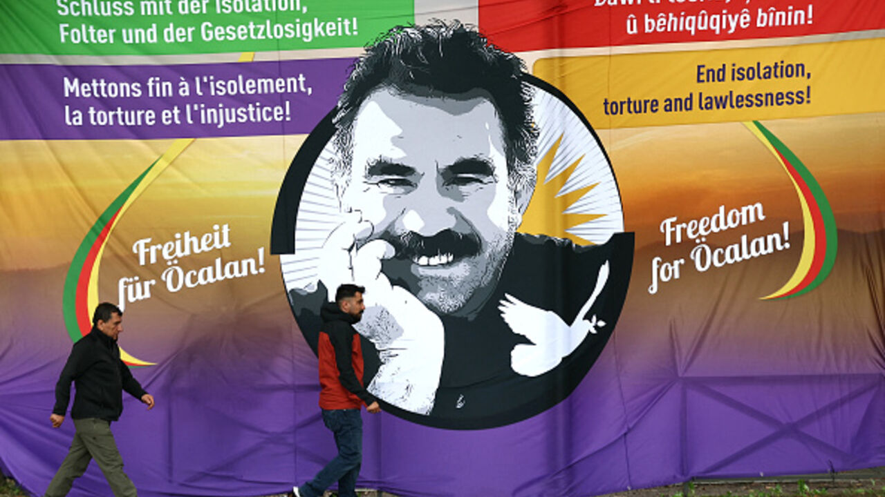 Participants walk past a banner depicting leader of former Kurdistan Worker's Party (PKK) Abdullah Ocalan, during a demonstration in front of the European Council asking for Ocalan's liberation in Strasbourg, Eastern France, on September 15, 2025. (FREDERICK FLORIN/AFP via Getty Images)