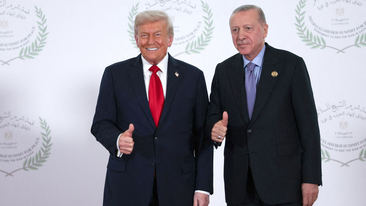 US President Donald Trump and Turkish President Tayyip Erdogan gesture as they pose for a photo during a world leaders' summit on ending the Gaza war on Oct. 13, 2025 in Sharm El-Sheikh, Egypt. 