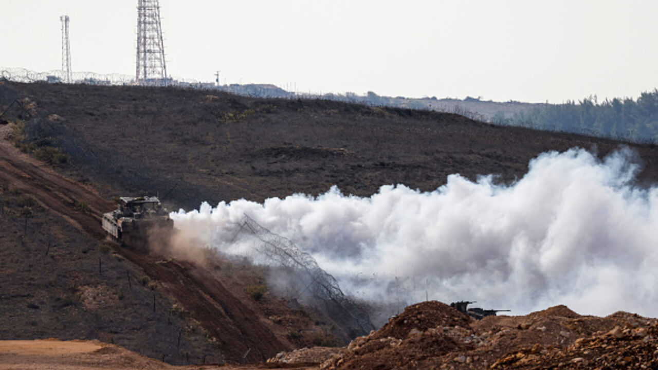 An Israeli military tank patrols along the border fence separating northern Israel from southern Lebanon on November 24, 2025. Hezbollah held the funeral on November 24 for its top military chief and other members of the militant group a day after Israel killed them in a strike on Beirut's southern suburbs. (Photo by Jalaa MAREY / AFP via Getty Images)