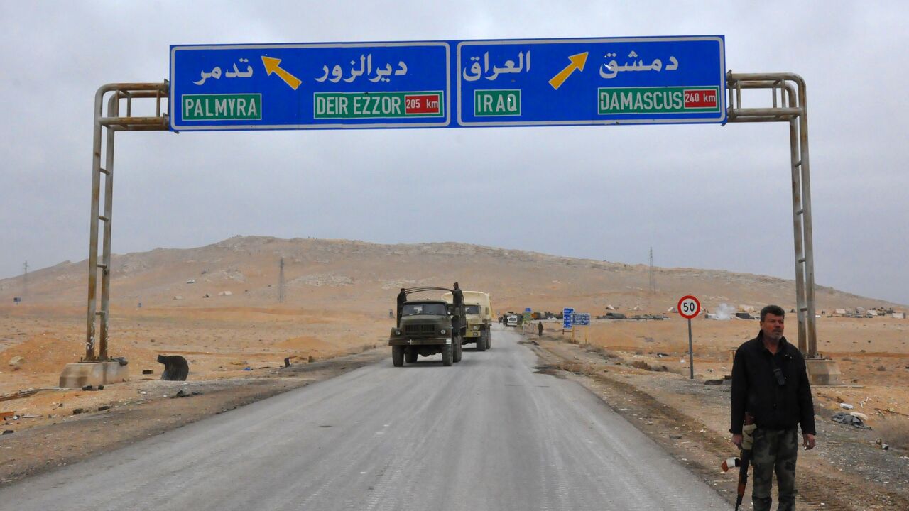A picture taken on March 2, 2017, shows a sign displaying the routes to Palmyra-Deir Ezzor and Damascus-Iraq as Syrian regime fighters advance to retake the ancient city of Palmyra, from Islamic State (IS) group fighters. / AFP PHOTO / STRINGER (Photo credit should read STRINGER/AFP via Getty Images)
